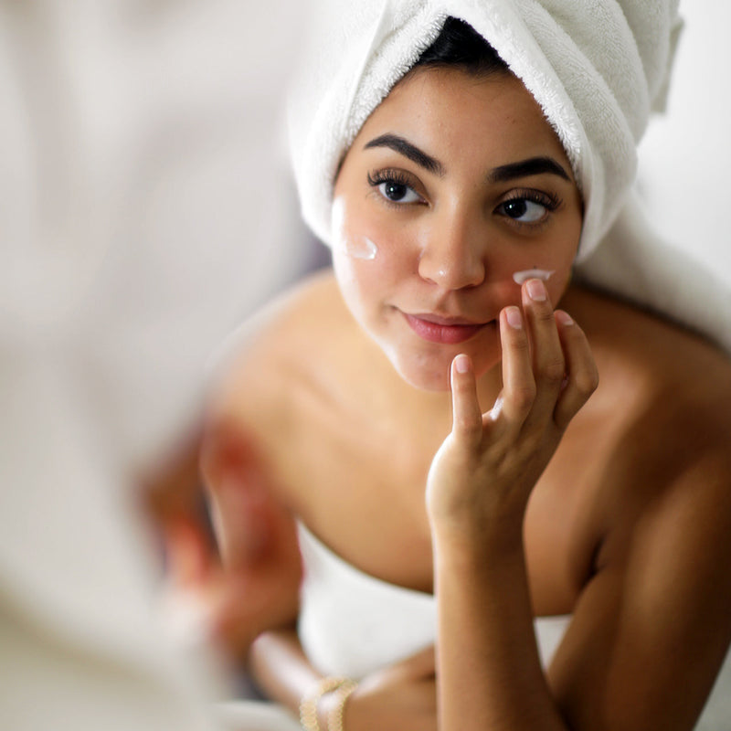 Woman in spa-like bathroom with her Civant product evening routine